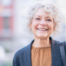 A woman is happy as she applies senior incontinence management tips.